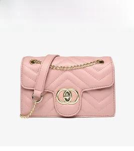 Close-up of pink quilted PU leather bag with golden ring clasp and metal chain strap