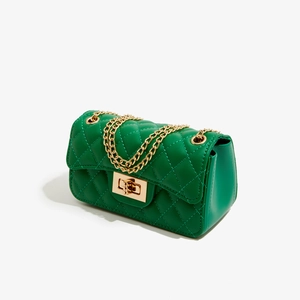 Detail of emerald green quilted PU leather mini bag with gold chain strap and turn-lock