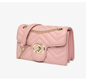 Detail view of pink quilted PU leather crossbody bag with triple gusset structure