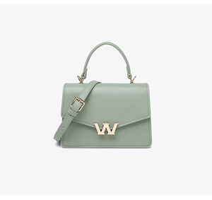 Detail of light green PU leather crossbody bag with a golden W-shaped metal buckle clasp