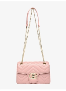 Close-up of pink quilted crossbody bag featuring V-shaped stitching and gold-tone hardware