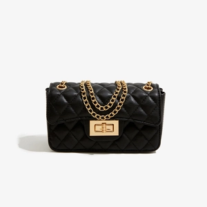 Detailed close-up of a black quilted PU leather shoulder bag with a gold metal twist lock