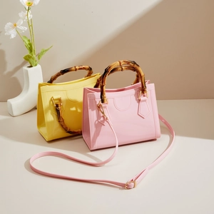 Detailed view of fashionable jelly handbags featuring vintage bamboo handles and crossbody strap