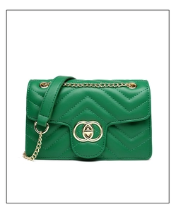 Detail of green PU leather crossbody bag with V-quilted pattern and golden metal lock