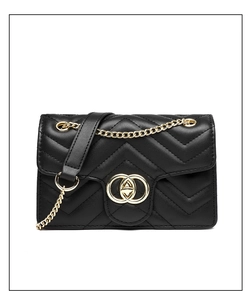 Macro detail of black quilted faux leather bag with elegant gold interlocking buckle
