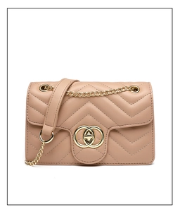 Close-up of beige quilted leather crossbody bag with V-shaped stitching and golden hardware