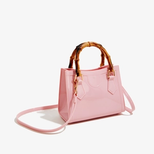 Detail view of pink PVC jelly bag with bamboo handle and adjustable shoulder strap