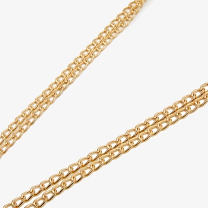 Detail shot of the shiny double-layered golden metal chain strap on a small PU bag