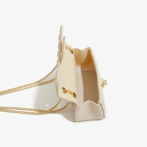 Detailed interior view of beige quilted PU crossbody bag with golden chain and clasp