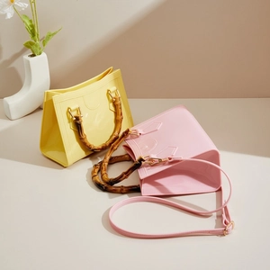Fashionable PVC jelly crossbody bag with bamboo handle in bright yellow and pink colors