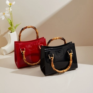 Glossy square jelly handbag with natural bamboo handle and gold hardware in red and black