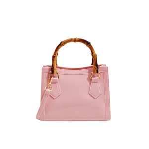 Pink transparent jelly handbag featuring vintage bamboo handles and a long shoulder strap