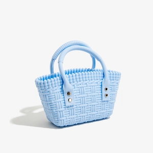 Detail der hellblauen gewebten PVC-Gelee-Tasche mit Metallnieten und klassischer Flechtstruktur