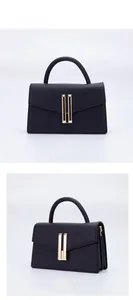 Detail view showing front and side of black handbag with golden H-shaped metal lock closure