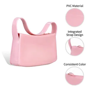 Pink PVC jelly handbag with minimalist integrated shoulder strap and zipper closure