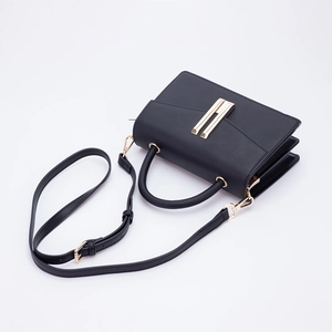 Chic black matte leather crossbody bag featuring a distinctive golden H-shaped metal clasp
