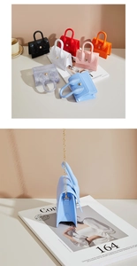 Detail shot of multi-color mini PVC jelly bags with gold chain and handle in fashion layout
