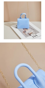 Detailed macro view of the sky blue jelly bag with elegant gold chain and handle linkage