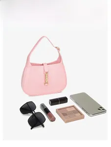 Pink PVC crescent hobo bag interior capacity showing phone and makeup essentials