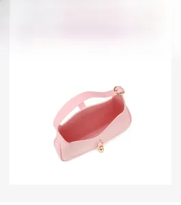 Detailed interior view of pink PVC crescent bag showing surprisingly ample storage capacity