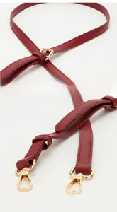 Detailed view of the dark red PU leather strap with adjustable gold buckle and metal hook
