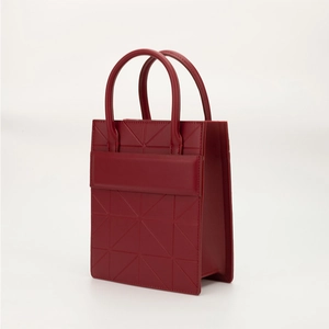 Modern red geometric tote bag with 3D triangle pattern and dual top handles