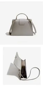 Detail view of the gray Saffiano leather crossbody bag showing the back and interior