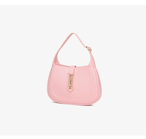 Close-up of pink crescent jelly bag featuring a classic gold piston lock and glossy finish
