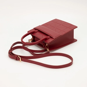 Dark red geometric paneled crossbody bag with stylish top handles and a golden strap clasp