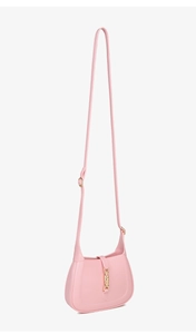 Detail of light pink crescent bag featuring a vintage golden piston lock closure