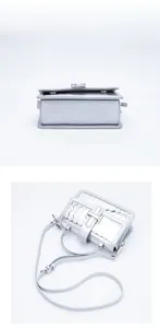 Detailed bottom and top views of silver crossbody bag with woven texture and metal buckle