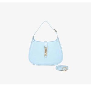 Detailed view of light blue PVC crescent hobo bag with iconic metallic piston closure