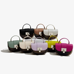 Collection of retro saddle bags with clear panels and metallic locks in eight vibrant colors
