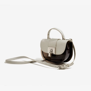 Modern semi-transparent brown saddle bag with beige leather trim and silver buckle