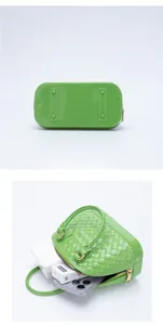 Detail of bright green woven jelly bag showing the interior and metal studs on the bottom