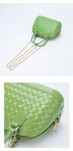 Detailed macro view of green PVC woven texture and golden chain on fashion jelly bag