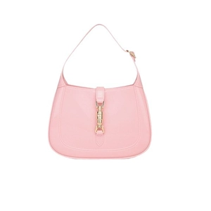 Pink PVC half-moon shoulder bag with golden piston clasp and sleek minimalist design