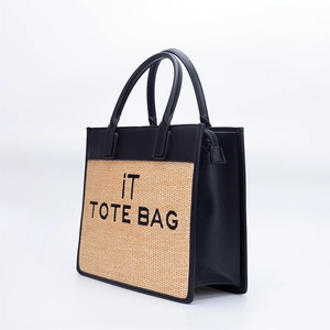 Fashionable straw tote bag with black leather handles and 'IT TOTE BAG' embroidery