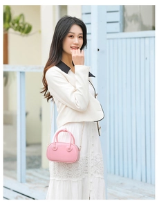 Chic pink PVC jelly cross-body bag featuring a sweet heart charm and chain strap detail