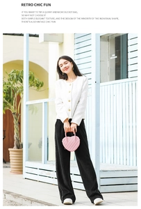 Outdoor street style shot of a pink heart-shaped bag with classic quilted diamond pattern