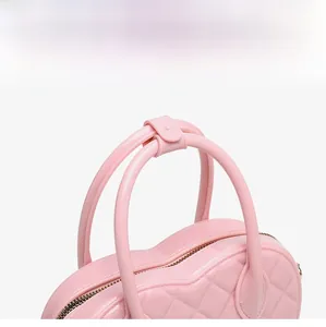 Detailed close-up of pink heart-shaped jelly bag showing quilted texture and handles