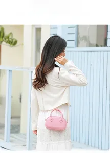 Chic pink jelly PVC handbag shown with metal chain strap on model for summer outfit