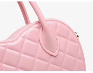 Detail of pink heart-shaped PVC jelly bag with quilted diamond pattern and neat stitching
