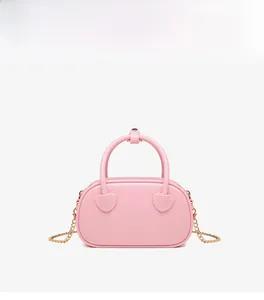 Detailed view of pink heart-shaped decorative ornaments on a sleek jelly evening handbag