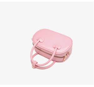 Detailed top view of pink PVC jelly bag showing heart-shaped handles and gold zipper