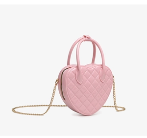 Close-up of heart-shaped PVC jelly bag with quilted pattern and gold chain strap