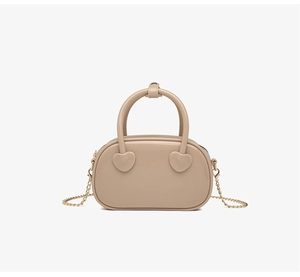 Detail view of milk tea PVC jelly bag with heart-shaped accents and gold chain strap
