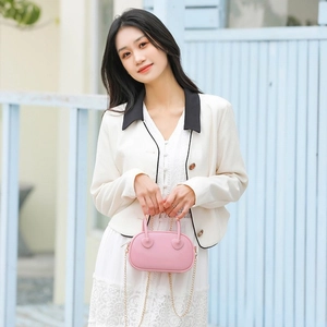 Chic pink PVC jelly bag with heart details and gold chain strap for summer style