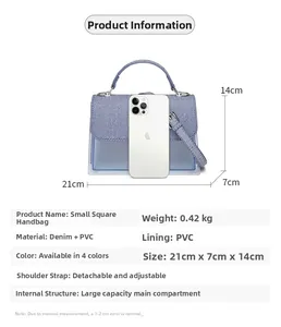 Detail view of denim and PVC crossbody bag showing 21x7x14cm size and phone comparison