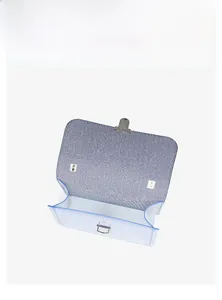 Detail view of the interior capacity of a blue jelly crossbody bag with turn-lock